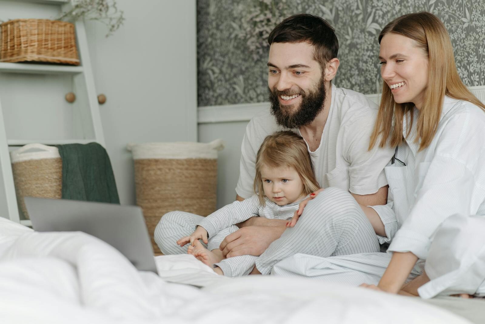 Photo by Pavel Danilyuk Family of three enjoying bonding time watching a laptop together at home.